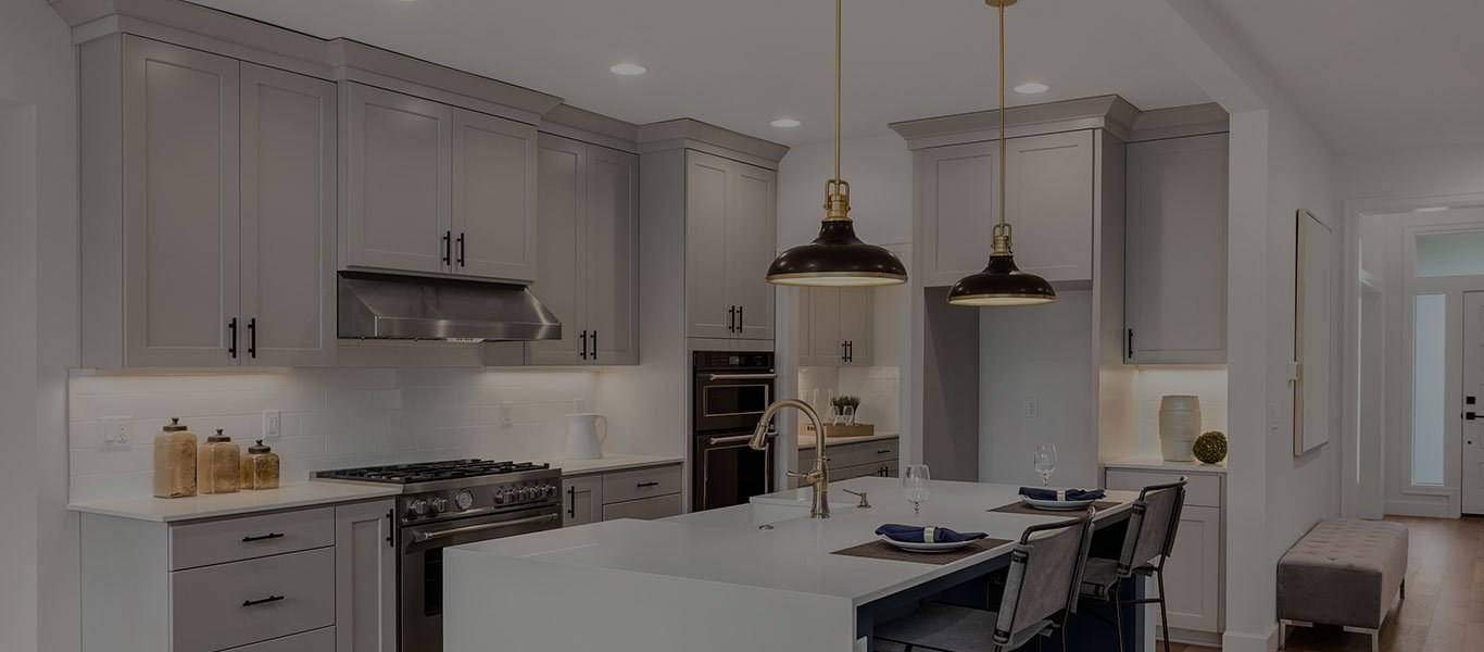 A kitchen with gray painted cabinets and an island