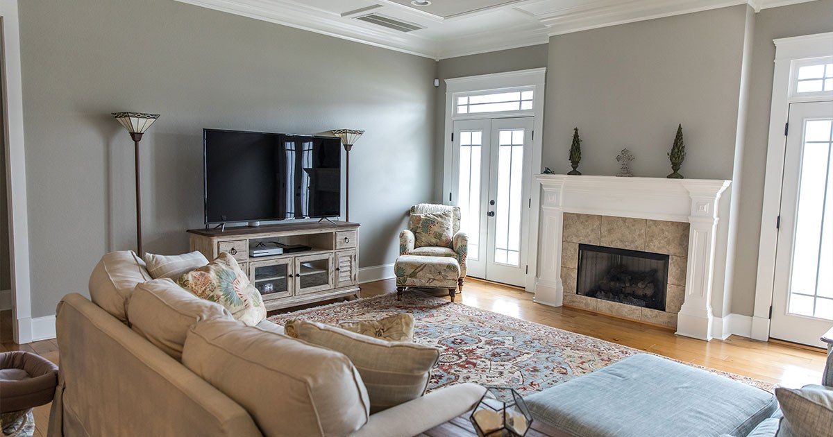 An elegant living room with neutral painted walls and a fireplace