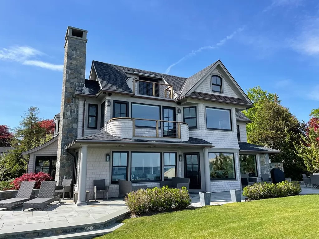 A large lake-area home with a fresh exterior paint finish