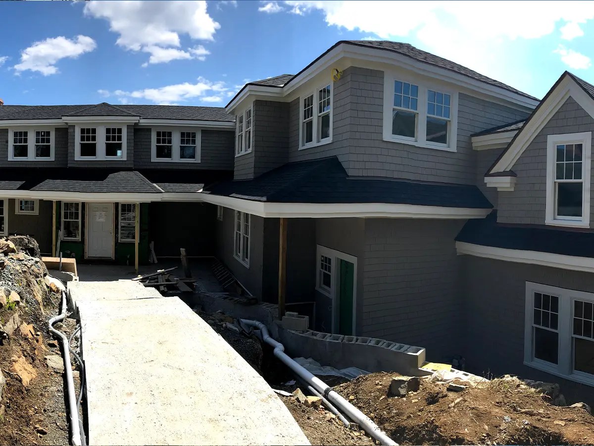 A large gray home with a fresh whole-house paint finish