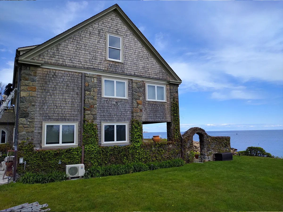 A shingle-sided home with a fresh exterior paint finish