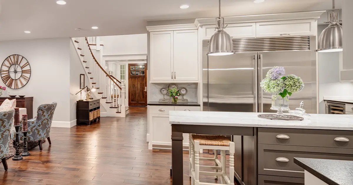 A bright open kitchen and living area with painted cabinetry