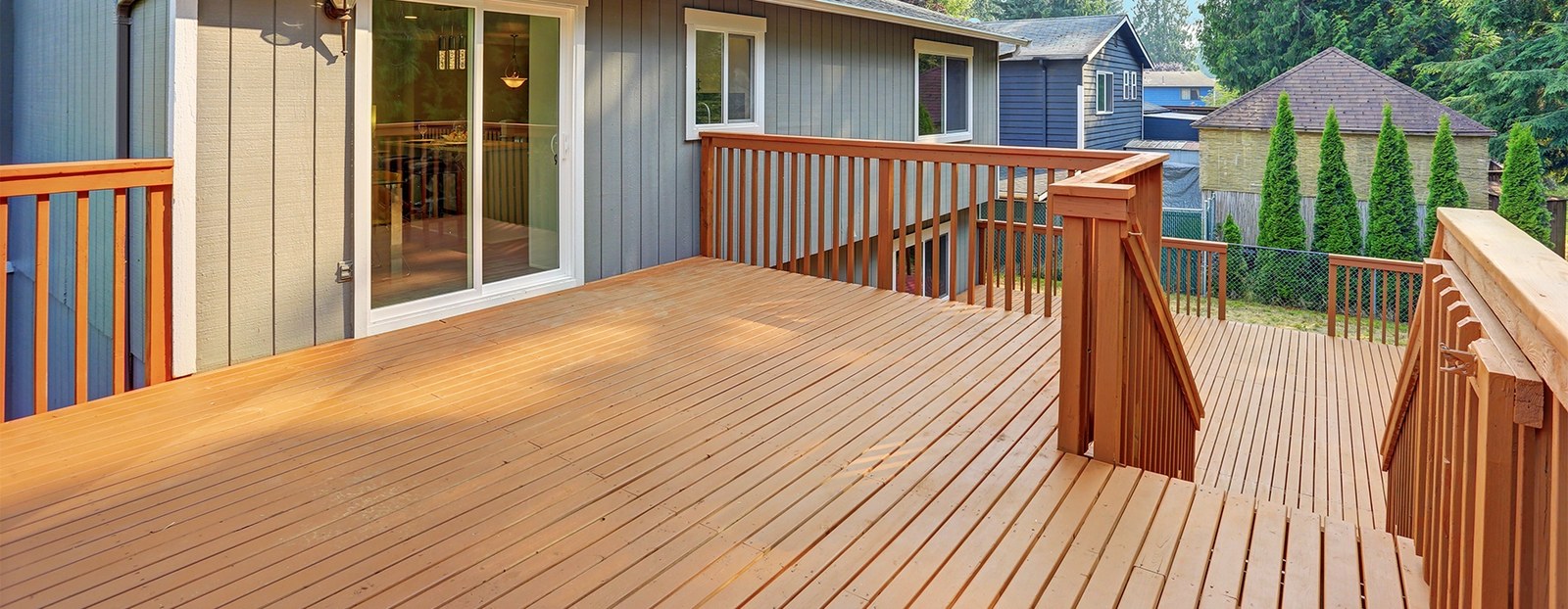 A freshly stained wooden deck with railings